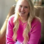 Annie Gerut, therapist at Renewed Stories Counseling, with curly hair and orange sweater, specializing in helping clients with anxiety and depression in Spokane