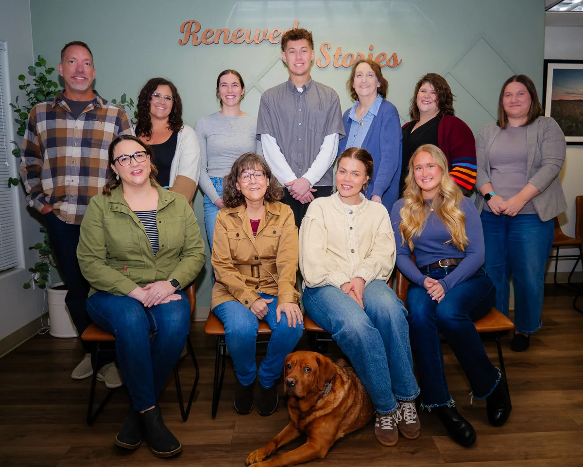 The therapy team at Renewed Stories Counseling gathered in their Spokane, WA office, with Murray the certified therapy dog