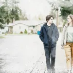 A parent and teenager talk while walking together through a quiet Pacific Northwest neighborhood A parent and teenager talk while walking together through a quiet Pacific Northwest neighborhood